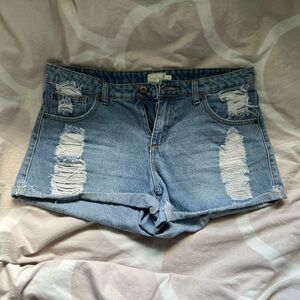 Timing classic blue jeans with distressing size large